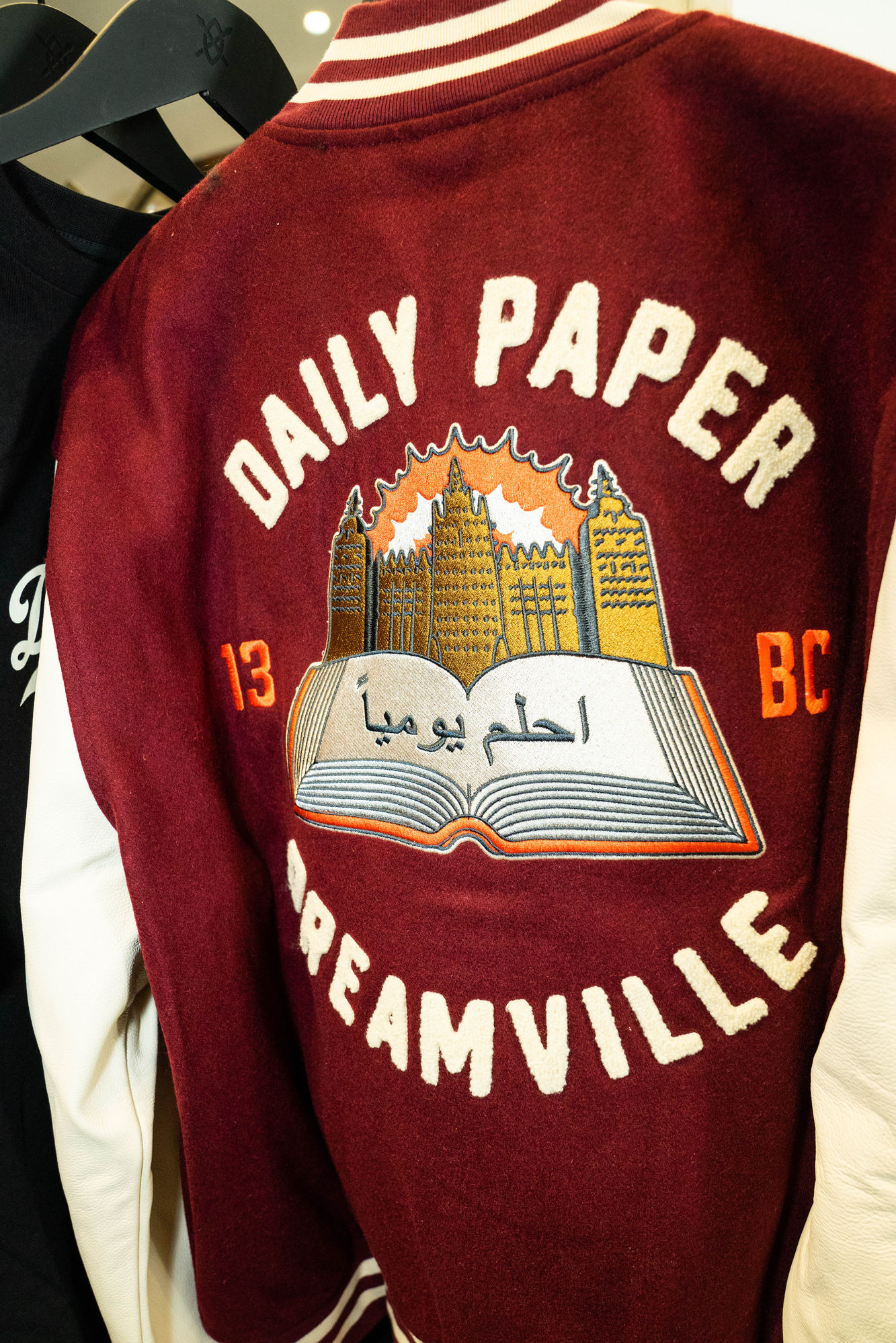 Detail of the Dream Daily varsity jacket back, embroidered Daily Paper × Dreamville, 13 BC, Mali