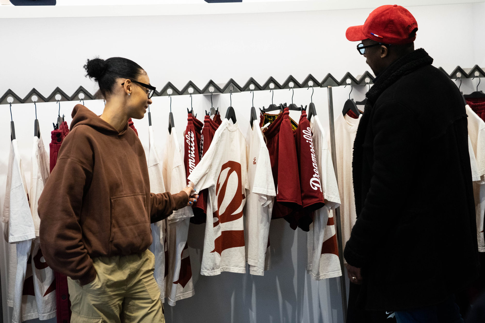 Two guests browsing the Dream Daily capsule rack at Daily Paper’s New York flagship