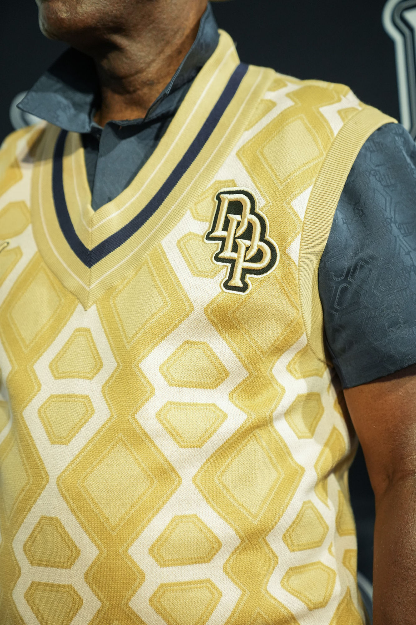 Detail of the monogram knit and DP patch on the PUMA × Dapper Dan vest