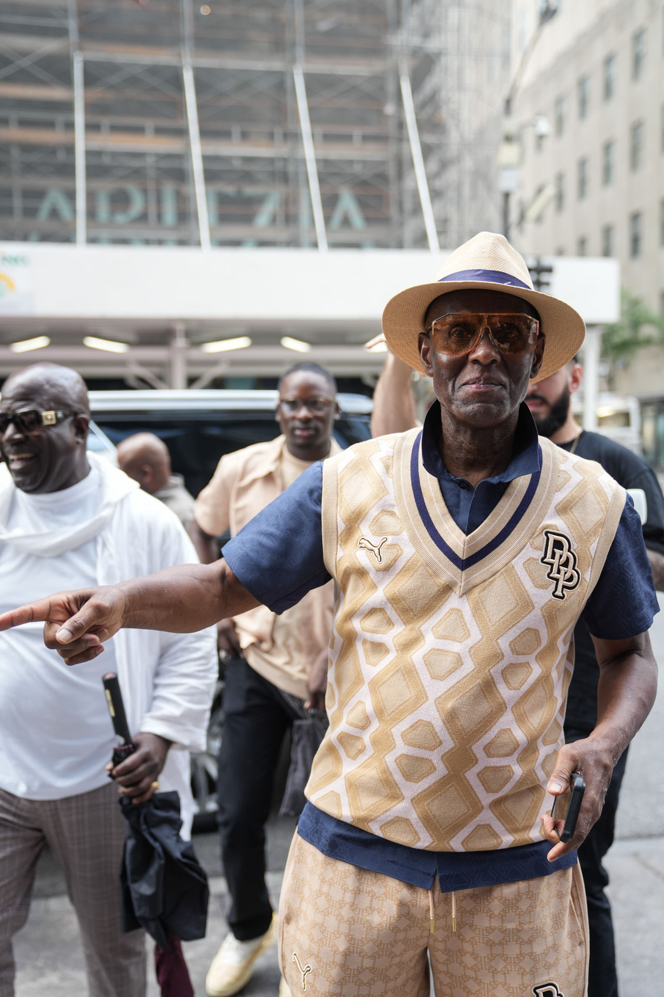 Dapper Dan pointing while walking through a crowd at the PUMA launch