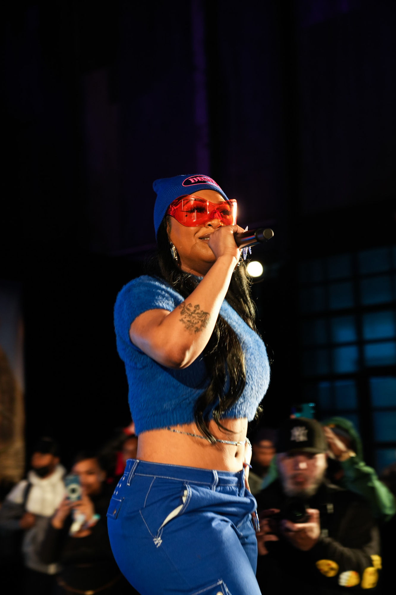 Performer on stage singing into a microphone at Air Max Day